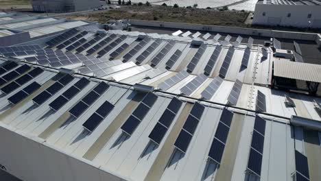 Drone-shot-of-solar-panels-on-roof-of-large-industrial-building