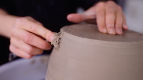 Potter-shaves-pottery-on-pottery-wheel