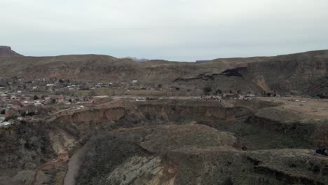 The-town-of-La-Verkin-in-the-southern-Utah-desert---pull-back-aerial-reveal