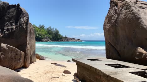 Mahe-Seychelles-white-sandy-beach-between-huge-granite-rocks,-turqoise-sea-water