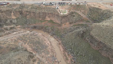 Tilt-down-aerial-reveal-of-the-Virgin-River-as-it-flows-by-Route-17-in-La-Verkin,-Utah
