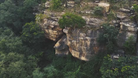 Aerial-closeup-drone-shot-of-a-bear-or-leopard-cave-in-a-Hill-at-a-dense-forest-of-Gwalior-,-India