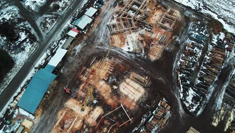 From-Forest-to-Home:-Aerial-View-of-a-Log-Home-Construction-in-the-Snowy-Wilderness-of-British-Columbia,-Canada