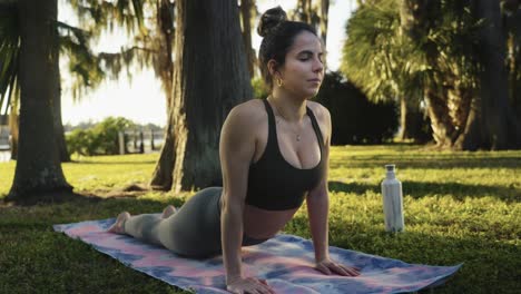 Beautiful-young-woman-concentrates-on-yoga-at-a-park