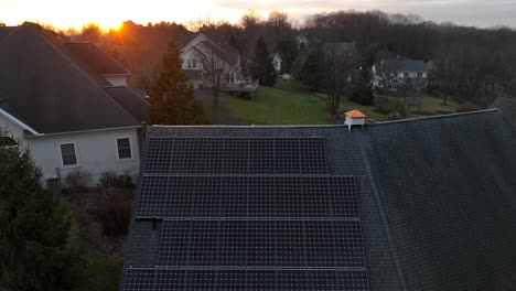 Aerial-rising-shot-of-solar-panels-on-sloped-roof-in-luxurious,-wealthy-neighborhood-in-America