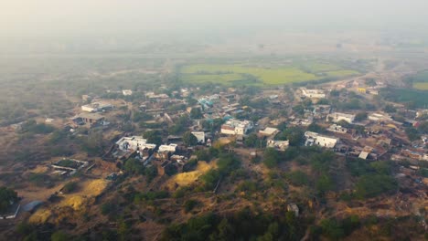 Aerial-drone-shot-of-an-Indian-village-in-winter-fog