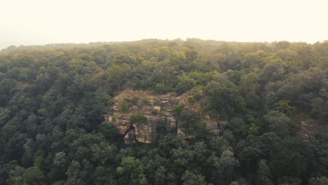 Aerial-drone-shot-of-Caves-in-a-Hill-at-a-dense-forest-of-Gwalior-,-India