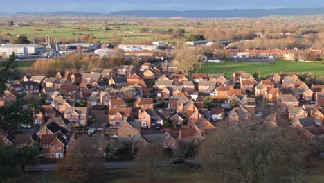 A-housing-estate-with-a-red-brick-group-of-houses-development-in-the-West-Country-town-of-Glastonbury-in-Somerset,-England