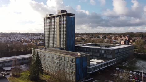Aerial-view-Pilkington's-glass-head-office,-a-modern-blue-high-rise-with-shared-office-space-and-townscape-orbit