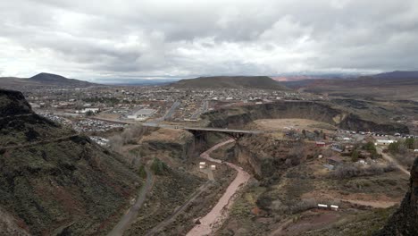 Flying-past-a-butte-to-view-a-bridge-over-the-Virgin-River-on-Utah-State-Route-17-in-La-Verkin