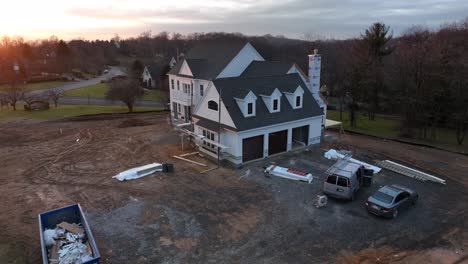Aerial-approach-towards-American-mansion-under-construction-during-winter-sunset