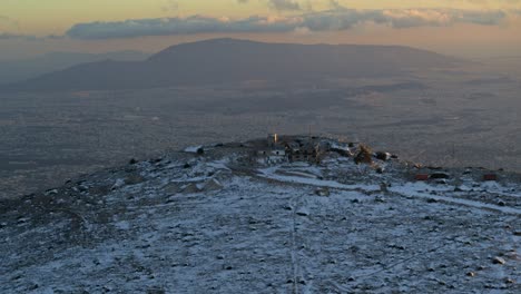 Aerial---Snowy-mountain---City-of-Athens-in-the-background-at-dusk---Shot-on-DJI-Inspire-2-X7-50mm-RAW