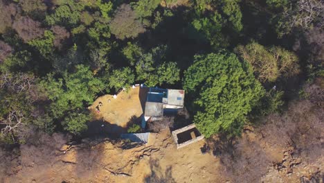 Aerial-drone-shot-of-a-ancient-temple-on-a-ridge-of-dense-forest
