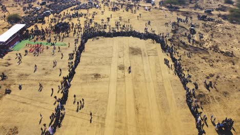 Aerial-Drone-shot-of-a-Crowd-of-Hundreds-of-People-at-a-Village-Event
