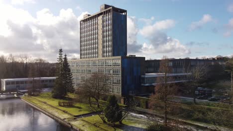 Aerial-view-Pilkington's-glass-head-office-frosty-gardens,-blue-industrial-high-rise-with-shared-office-space