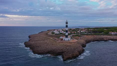 Aerial-pull-back-reveal-of-Artrutx-Lighthouse-in-Spain
