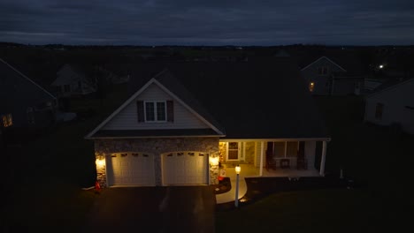 Lights-on-exterior-of-house-lit-up-during-blue-hour-in-American-neighborhood