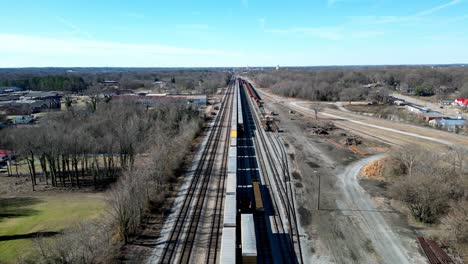 Long-straight-Railroad-track-with-Train-and-cars-in-Salisbury,-NC