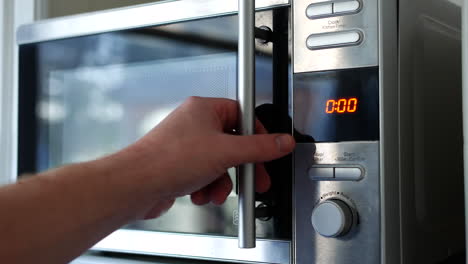 Using-Microwave-close-up.-Taking-meal-pot-out