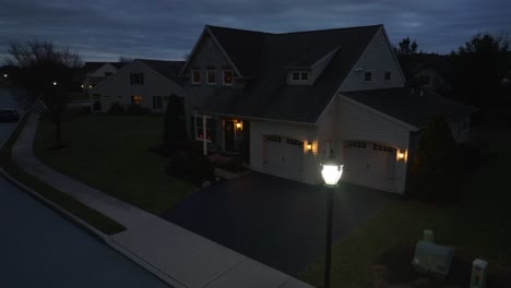 Large-American-home-during-blue-hour-dusk-with-street-light-and-lights-on-house