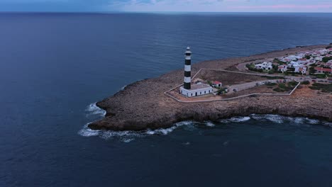 Aerial-tilt-up-reveal-of-Artrutx-Lighthouse-in-Menorca-Spain