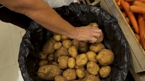 Taking-potato-from-bag-in-market
