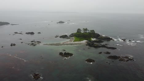 Cinematic-foggy-drone-fly-over-shot-descending-and-approaching-an-island-in-nootka-sound-off-the-west-coast-of-vancouver-island-british-columbia-bc-canada