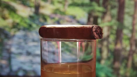 lit-cigar-on-top-of-whiskey-glass