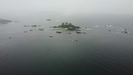 Cinematic-foggy-drone-fly-over-shot-approaching-an-island-in-nootka-sound-off-the-west-coast-of-vancouver-island-british-columbia-bc-canada