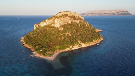 Rocky-Figarolo-Island-during-sunset-in-Golfo-Aranci,-Sardinia,-Italy---Aerial-4k