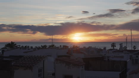 Time-lapse-of-fishing-village-rooftops-during-sunrise-over-the-sea