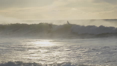Surfer-rides-big-wave-at-golden-hour-during-sunrise-in-this-breathtaking-video