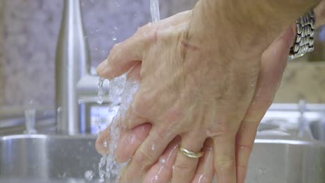 Slow-Motion-Of-Person-Washing-His-Hands-With-Soap-In-silver-Sink,-Personal-Hygiene