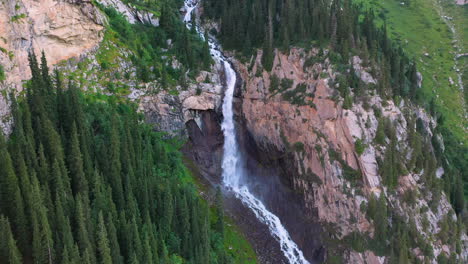Aerial-shot-Barskoon-Waterfall-in-Fairy-Tale-Canyon-in-Kyrgyzstan,-revealing-drone-footage