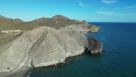 Rocky-Cliffs-and-Monsul-Beach-at-Cabo-de-Gata,-Almeria,-Andalusia,-Spain---Aerial-4k-Circling