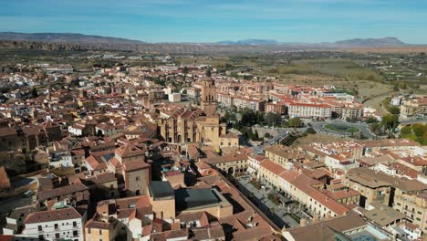 Guadix-city,-plaza-and-cathedral-in-Granada,-Andalusia,-Spain---Aerial-4k-Circling