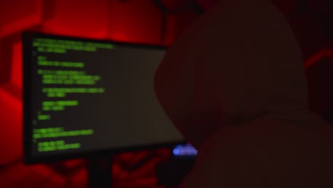 Anonymous-hacker-in-a-hoody-writing-code