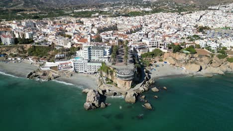 Nerja-Coastal-Village-and-Balcon-de-Europa-in-Malaga,-Costa-del-Sol,-Andalusia,-Spain---Aerial-4k-Birdseye-Tilting-Up
