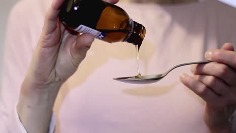 Healthcare-pouring-cough-medicine-in-a-teaspoon-stock-video-stock-footage