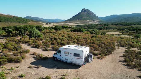 RV-Camper-Motorhome-Parked-in-Nature-of-Sardinia,-Italy---Aerial-4k-Circling