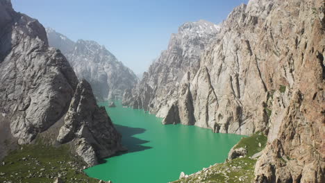 Epic-cinematic-revealing-drone-shot-of-the-large-ravine-surrounding-the-Kel-Suu-lake-in-Kyrgyzstan