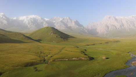 Epic-cinematic-aerial-drone-shot-of-the-mountains-surrounding-the-Kel-Suu-lake-in-Kyrgyzstan