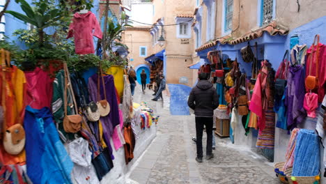 Walking-POV-in-street-market-in-Chefchaouen,-Morocco