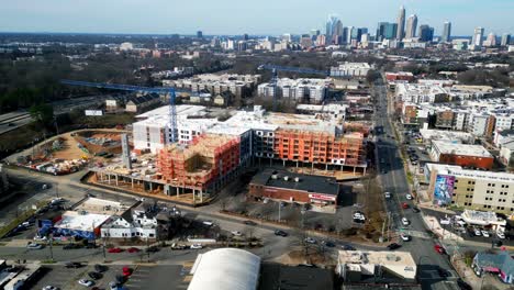 Charlotte-NC-Plaza-Midwood-Construction-aerial-orbit-with-skyline-in-view