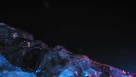 Glatte-Fesselnde-Pfanne-Aus-Einem-Violetten-Amethystkristall,-Der-Vor-Einem-Schwarzen-Hintergrund-Beleuchtet-Wird