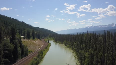 Aerial-descent-to-Bow-River-and-railroad-tracks-in-Canadian-Rockies