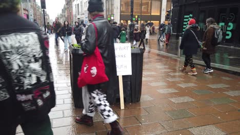Two-Pro-Trans-signs-against-a-planter-on-a-busy-Scottish-street