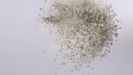 Slow-Motion-Shot-Of-Powder-Flying-In-The-Air-Against-White-Background