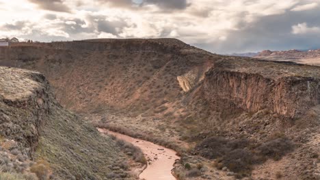 The-Virgin-River-flowing-through-a-steep-cliff-gorge-near-La-Verkin,-Utah---zoom-out-reveal-time-lapse