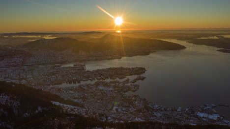 Beautiful-aerial-shot-revealing-the-city-of-Bergen-below-the-mountains-during-golden-hour